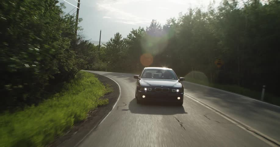 A car is driving on the empty road