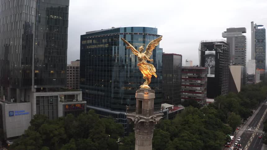 Gold statue known as the angel of independence is overlooking mexico city