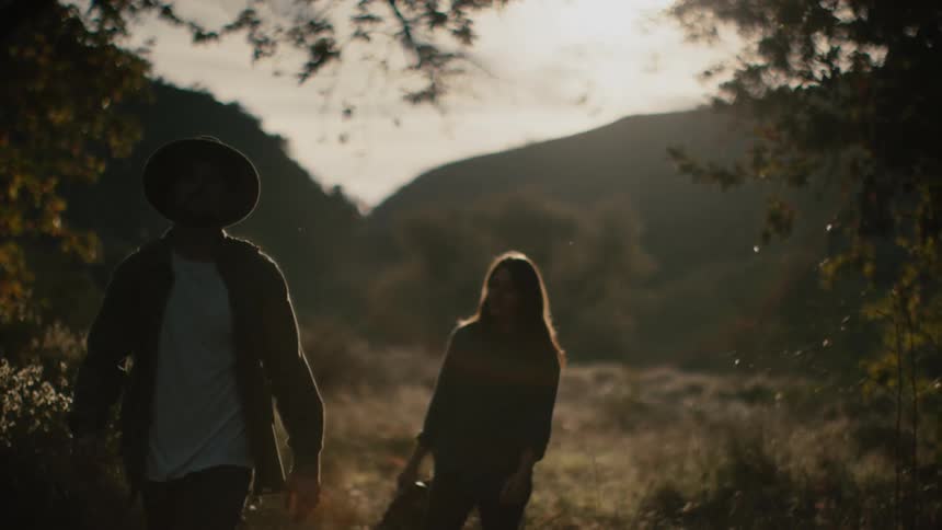 A man and woman walking outdoors