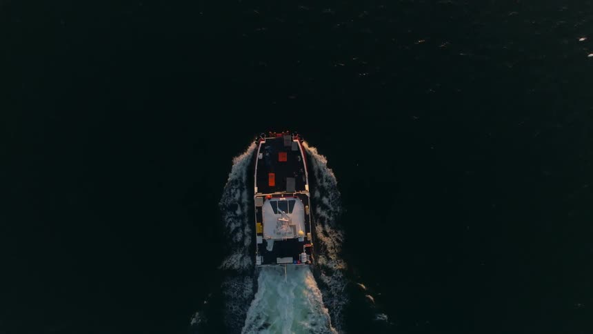An aerial view of a ship sailing on water