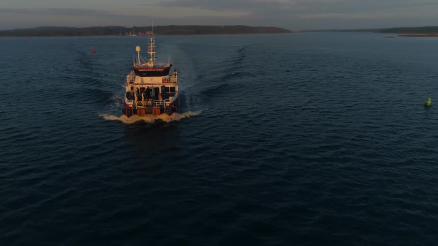 An aerial view of a ship sailing on the water