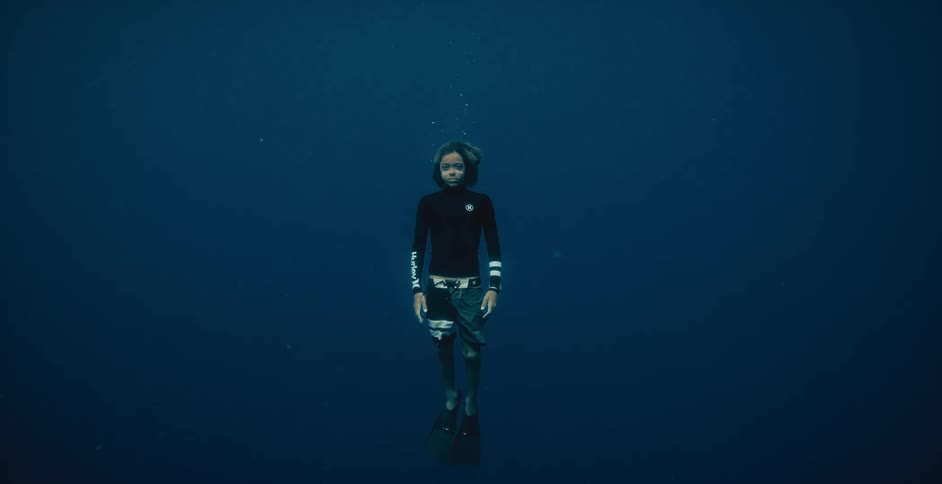 A woman diving under water