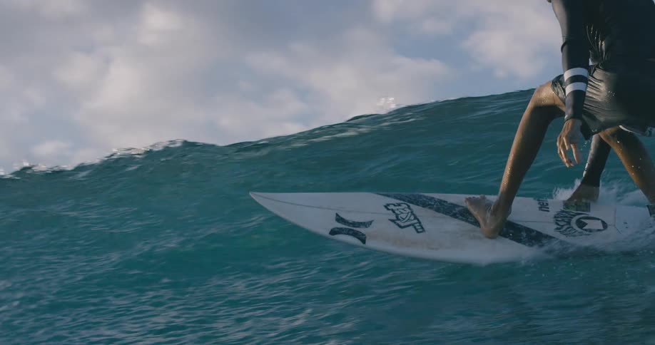 A teenage boys surfs in the ocean