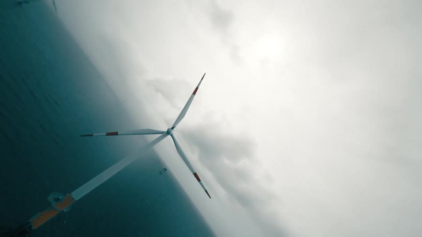 An aerial view of a windmill in the sea