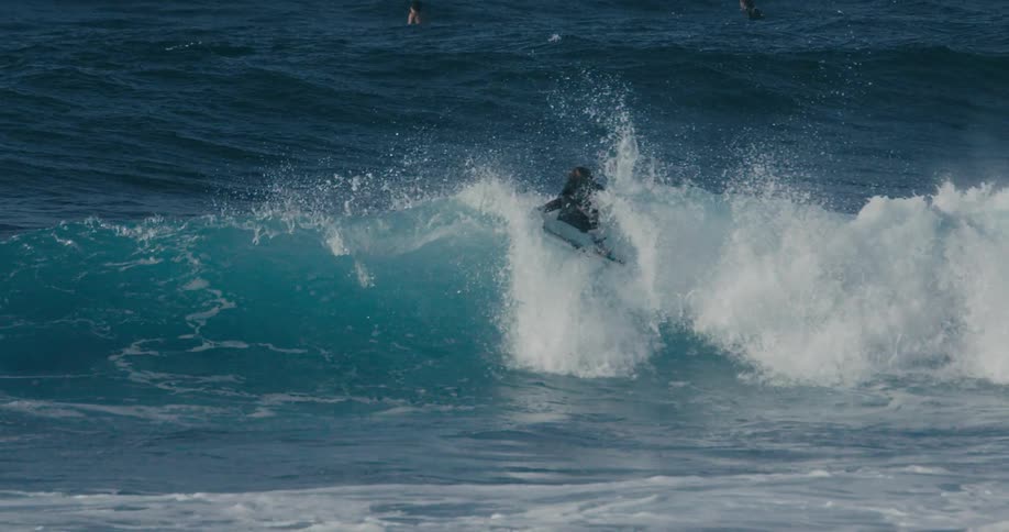 A man surfing outdoors on a wave