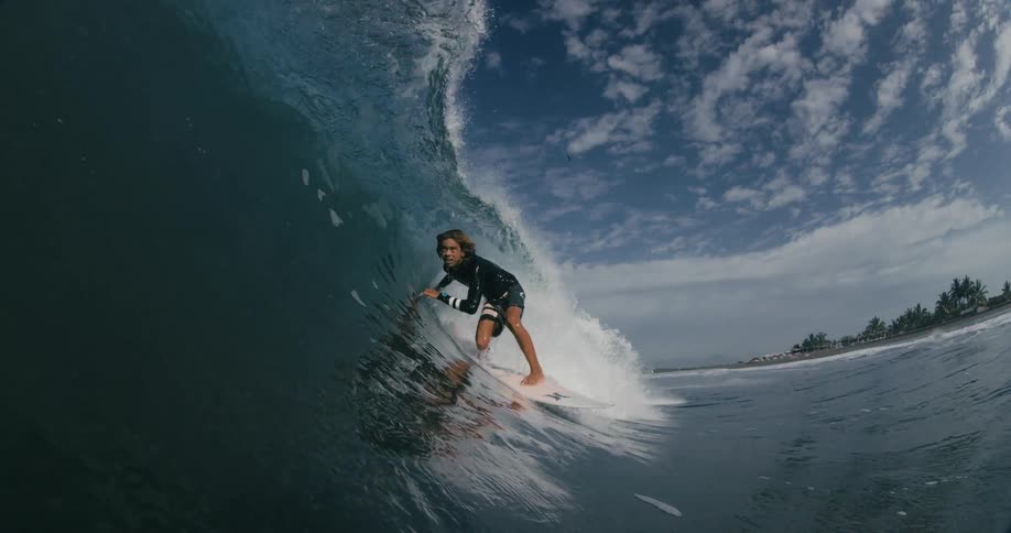 A man surfing on a large wave in the ocean