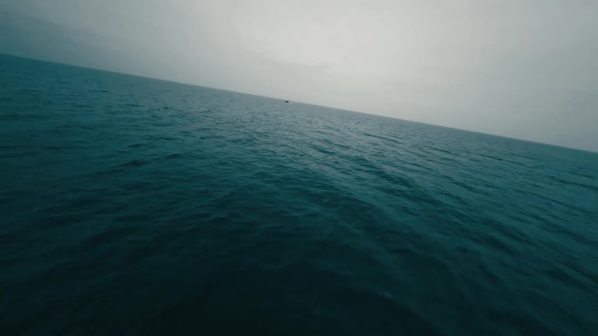 An aerial view of the ocean flying over