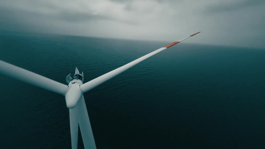 An aerial view of a windmill out in the sea