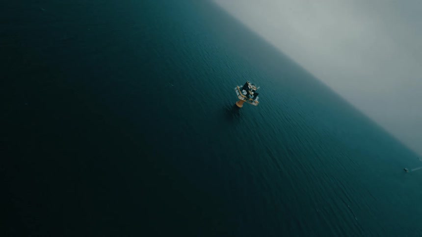 The windmill is in the middle of the ocean