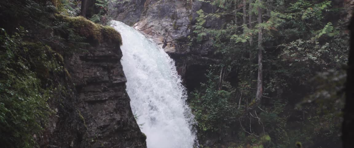 Rapid waterfall flowing in slow motion in the canyon