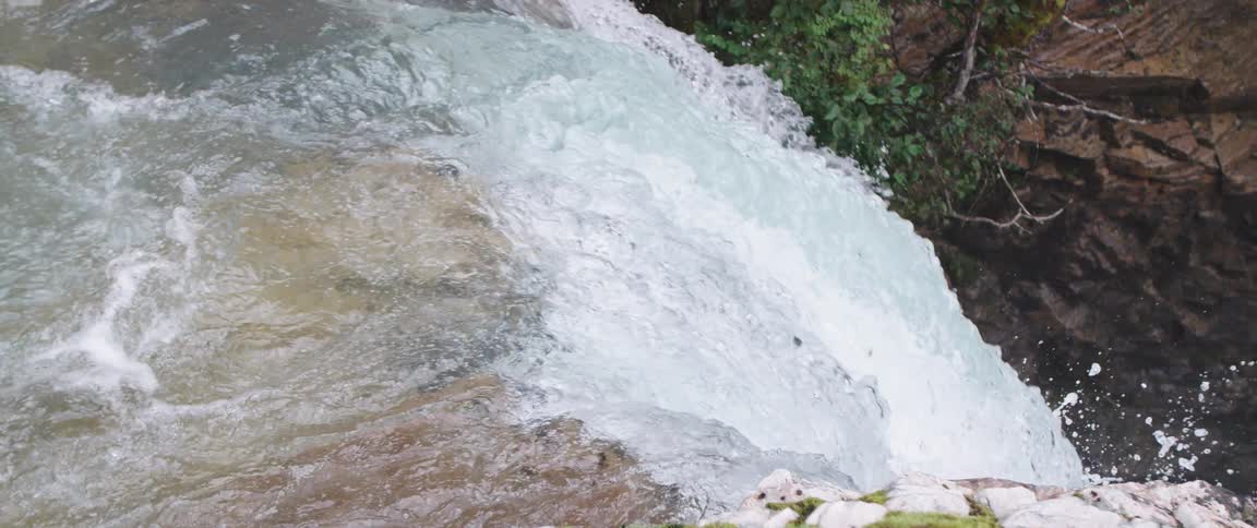 Aerial view of waterfalls as water goes over the edge