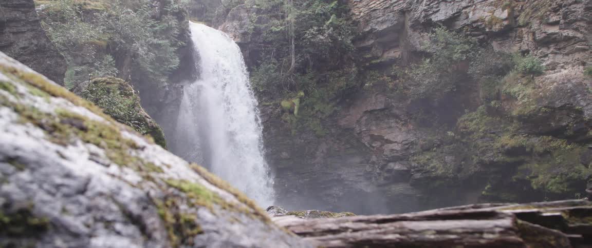 A waterfall in a canyon rapidly flowing in slow motion