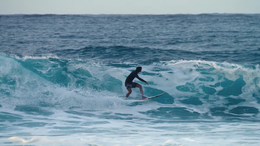 A surfer spins in the air after being sent airborne by a wave before failing the landing and falling into the ocean