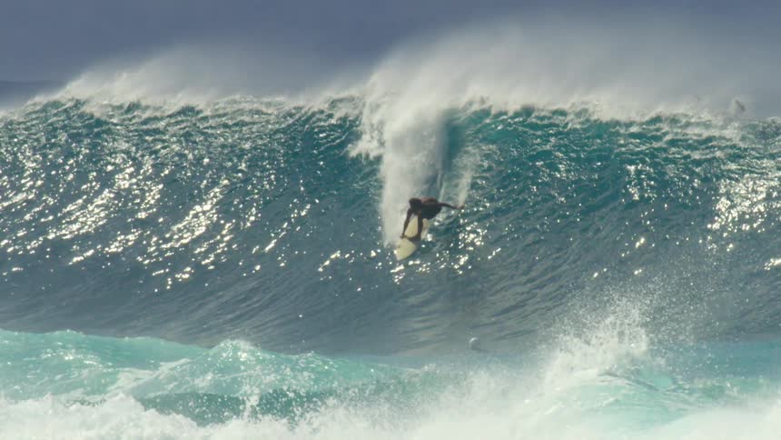 Male surfer rides a big wave