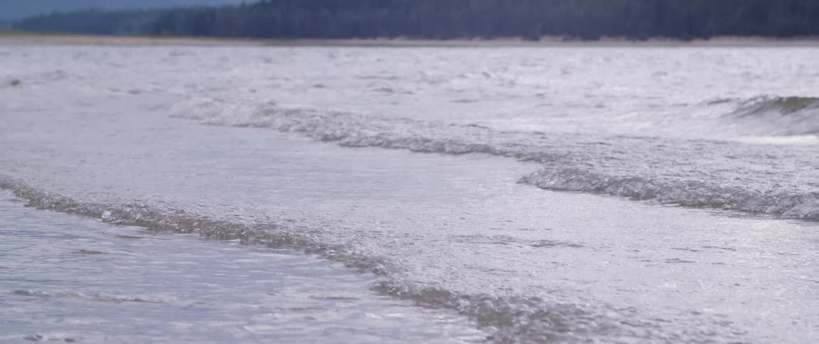 Waves roll in along the shore