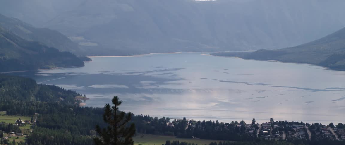 Homes sit along the shore of a lake covered in ice