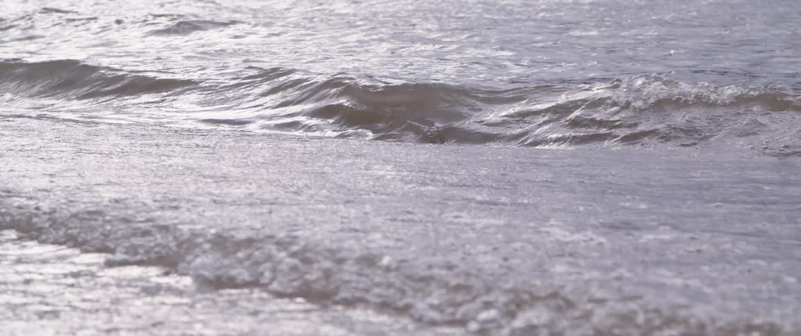 The waves crash against the shore