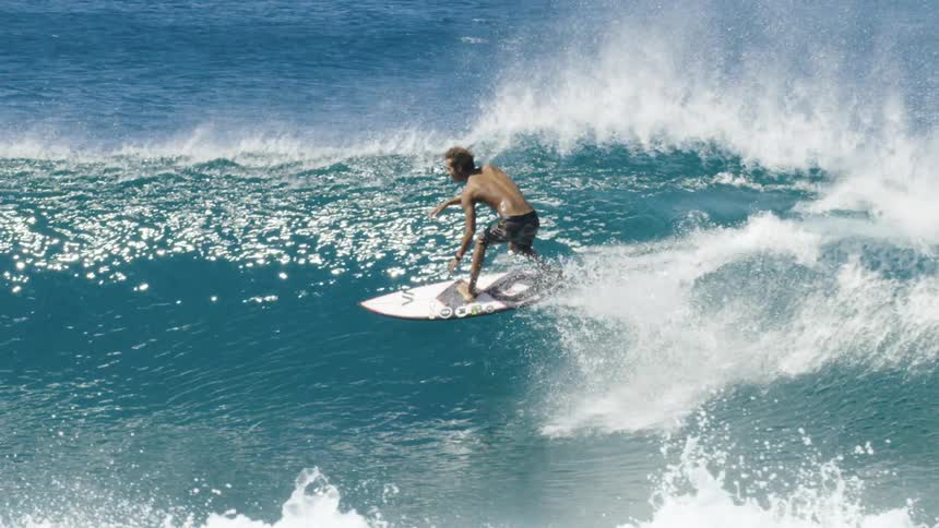 Surfer surfing on a wave in slow motion