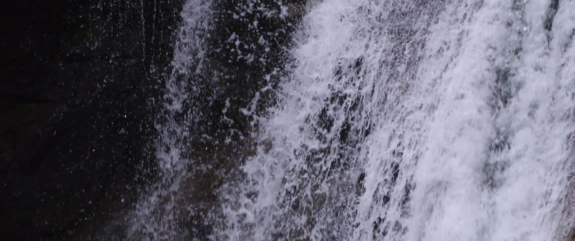 A waterfall is flowing into a river