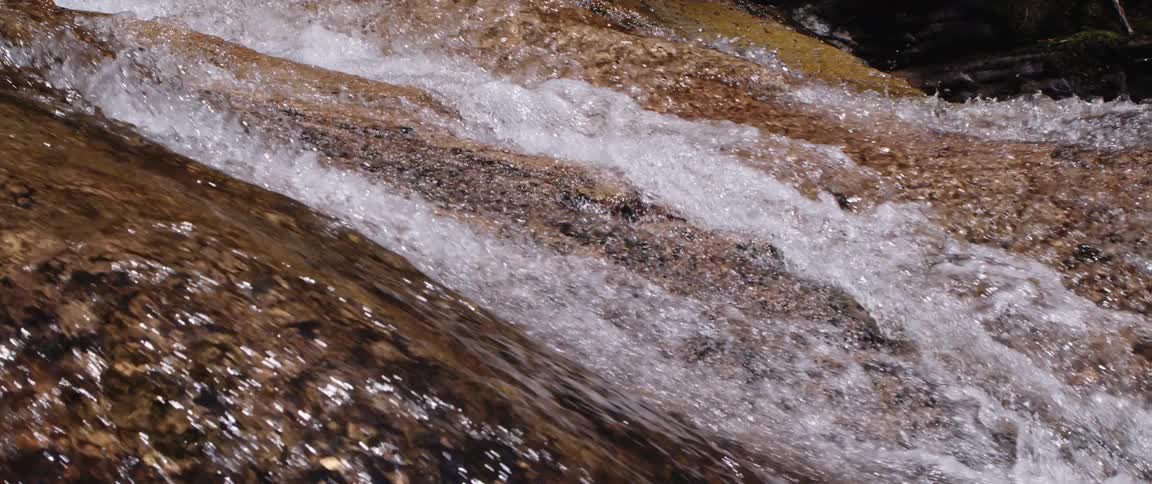The water rages over the rocks