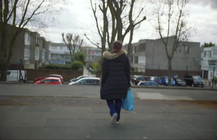 A woman walks down the stairs