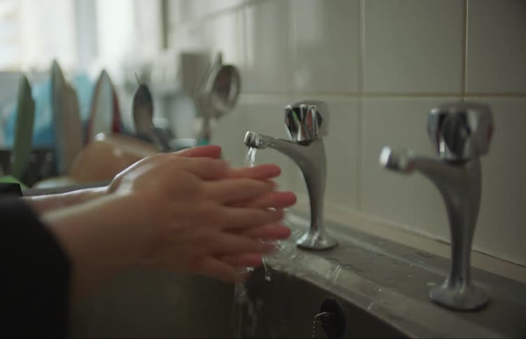 A person is washing their hands in the sink