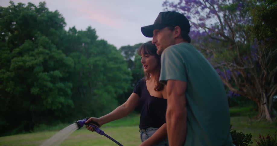 A man and woman working out in a garden