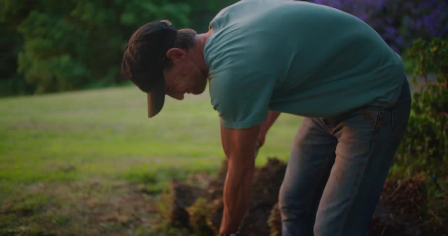 A man is shoveling mug from a bucket