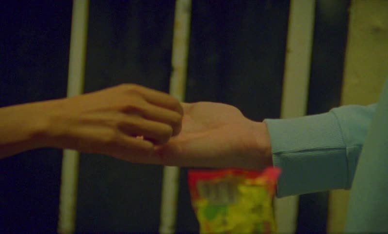 Person hold candy snack on palm allowing another person to take it