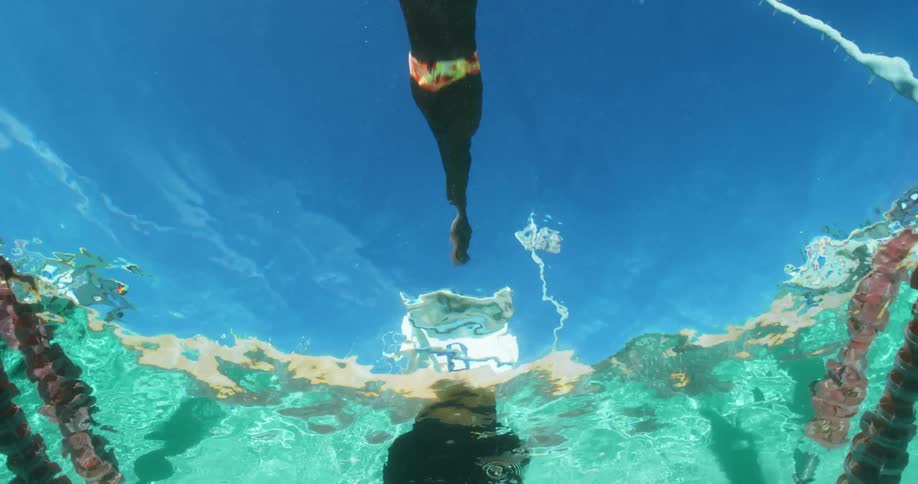 A man is diving into a pool of water