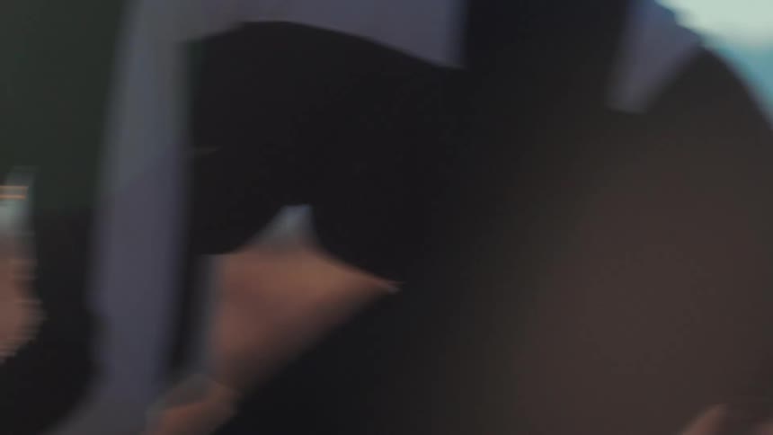 The silhouette of a man bending forward over the handlebars and pedaling fast and hard