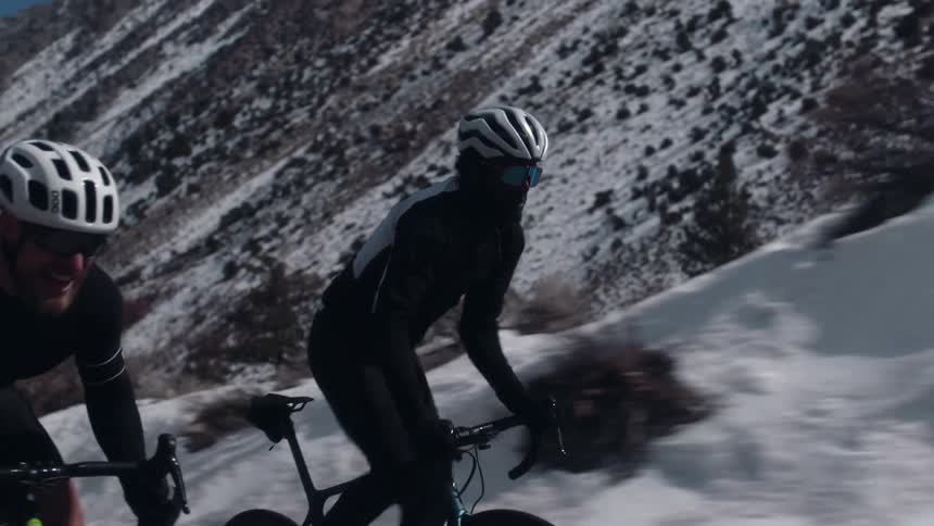 People are racing their bicycles by the mountain