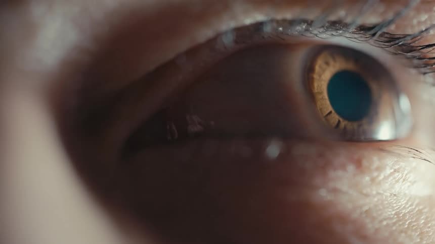 Close up of womans opening her brown eye