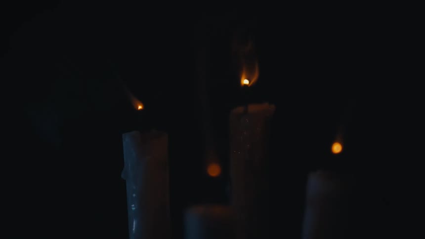 Burning candles gutter and extinguish leaving area in darkness