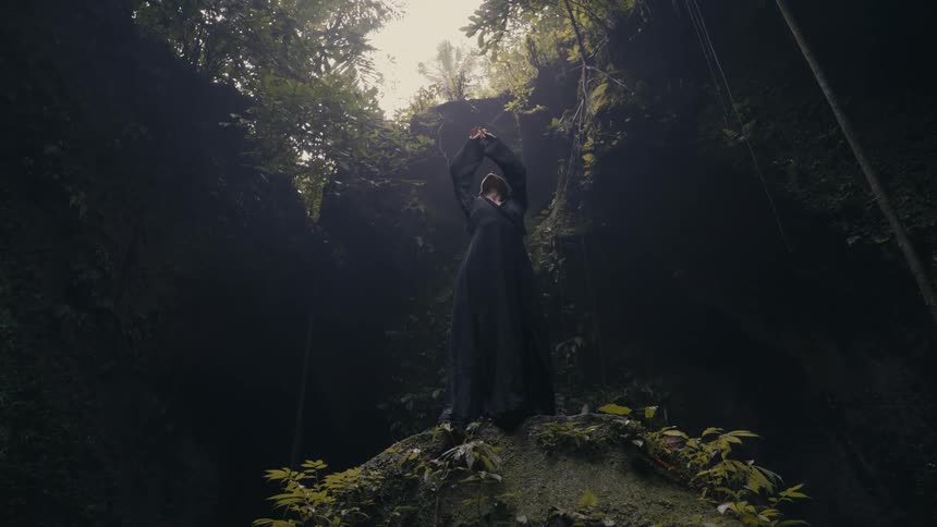 A woman is dancing outdoors in nature