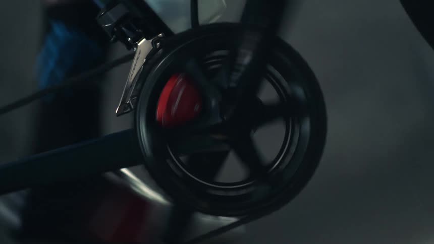 A person is peddling a stationary bike