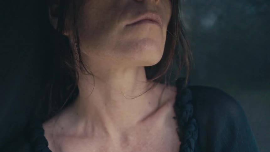 Close up of a woman with her face covered on a black veil floating in the wind