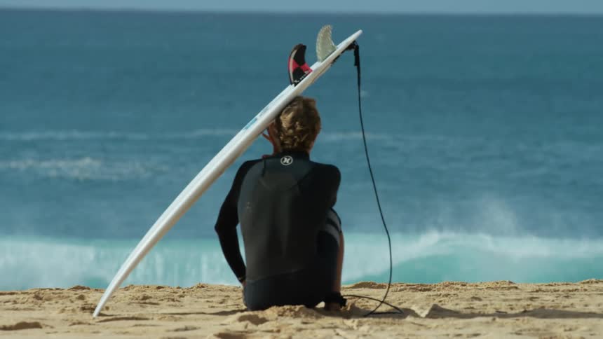 A woman is sitting on the beach in spring