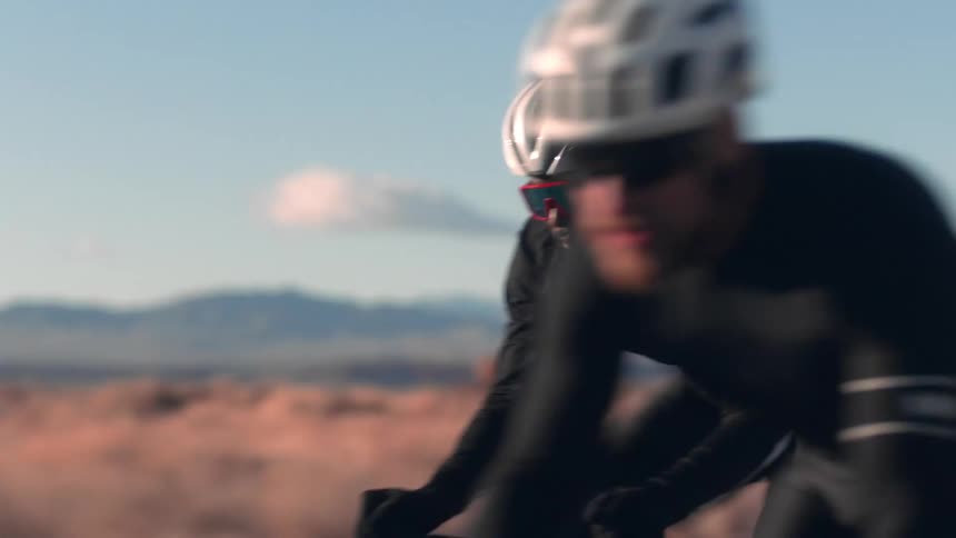 Two men are riding their bikes together