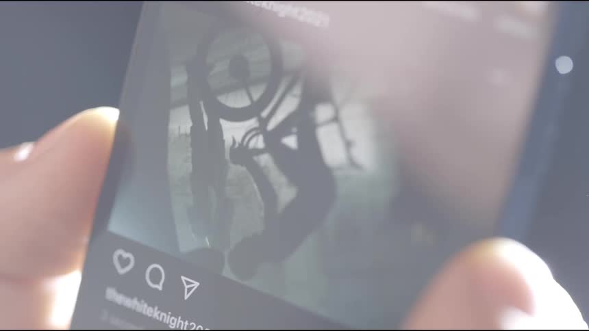 Person watches exercise video on their mobile phone