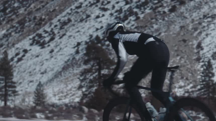 A person is racing his mountain bike past the mountain