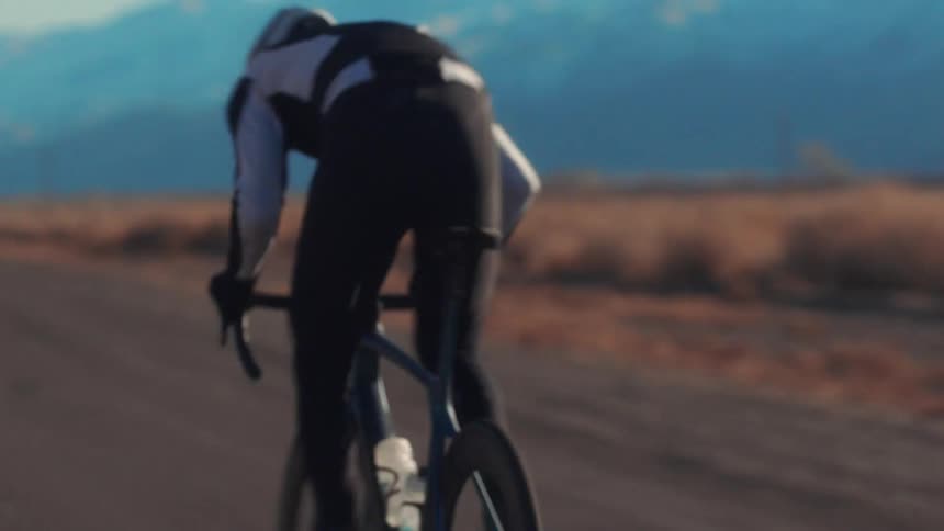A view of a person riding a bicycle on a road