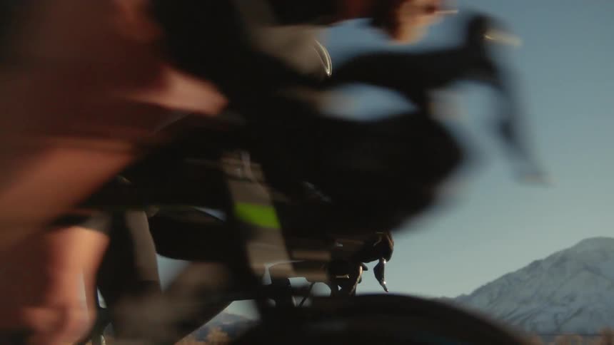 People on bicycles pass a racer