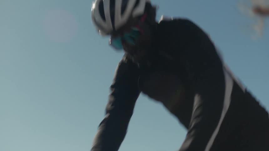 A person hopping onto a bike