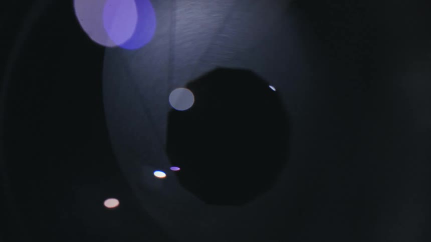 A camera lens opens and closes