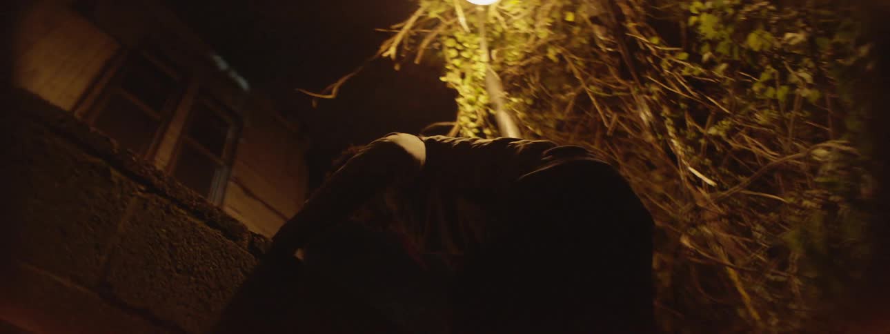 A man jumps up and over a wall