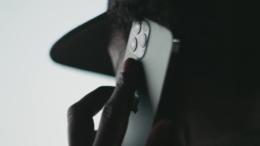 A man holds his cell phone to his ear