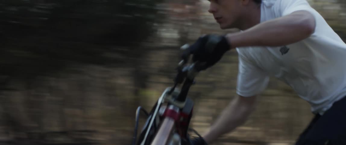 A man races his dirt bike through the park