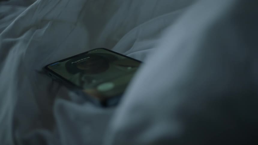 Woman receives call from person and picks up smartphone