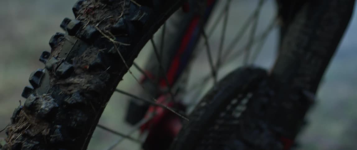 Narrow motorcycle tire is covered in mud